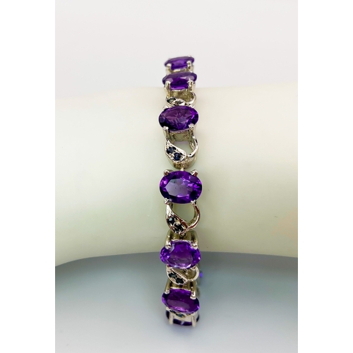 305 - An Amethyst & Sapphire Tennis Bracelet. Set in 925 Sterling silver. 33ctw. W- 24g. 18cm.