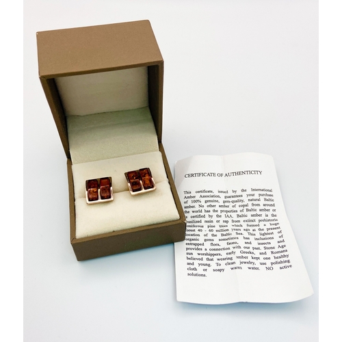 470 - A Pair of Amber and Silver Cufflinks. In original box with certificate. Ref: 016736