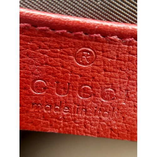 95 - A Gucci Monogram 'Tian' Clutch Bag. Leather exterior with a depiction of a bird in nature, red leath... 