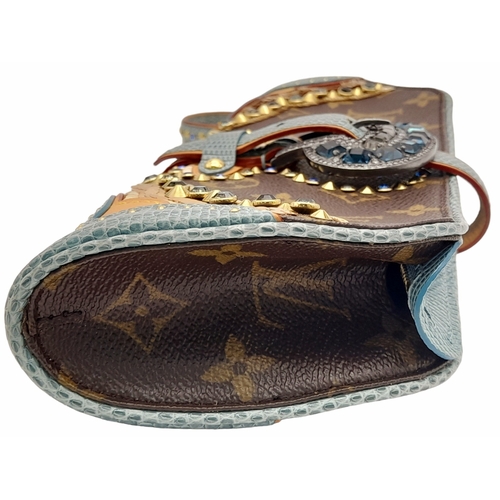 13 - A Louis Vuitton Monogram Les Extraordinaires Clutch Bag. Leather exterior with stone and stud embell... 