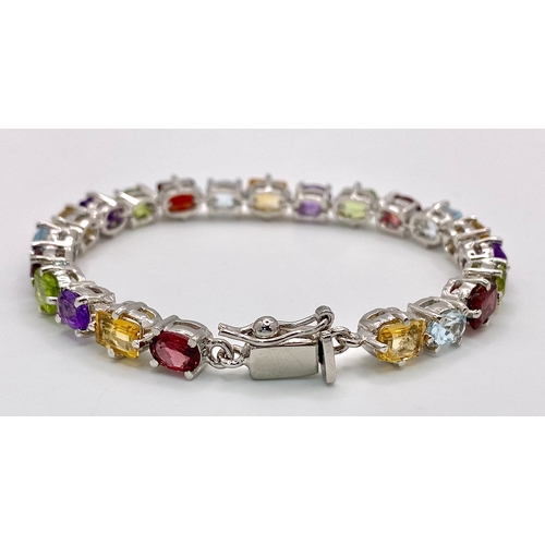 149 - A Multi-Gemstone Bracelet consisting of: Peridots, Amethysts, Blue topaz, Garnet Citrine & Rubies. S... 