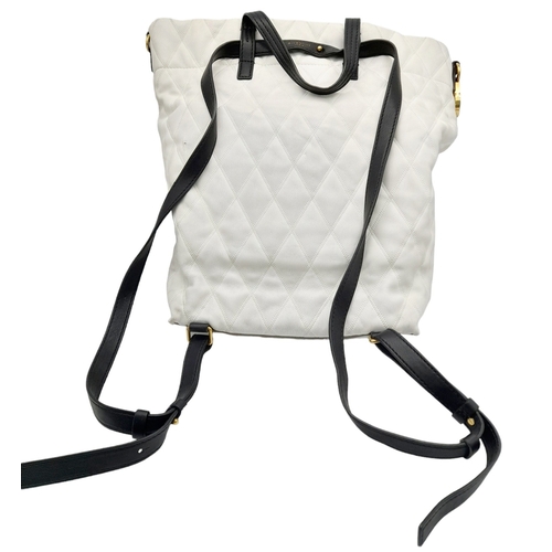 164 - A Givenchy Black and White Duo Backpack. Quilted leather exterior with gold-toned hardware, a zipped... 