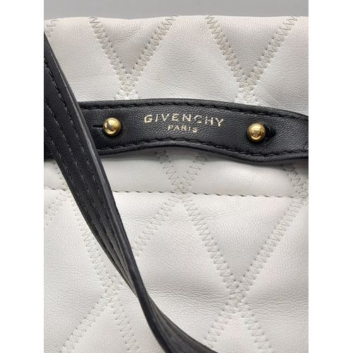 164 - A Givenchy Black and White Duo Backpack. Quilted leather exterior with gold-toned hardware, a zipped... 