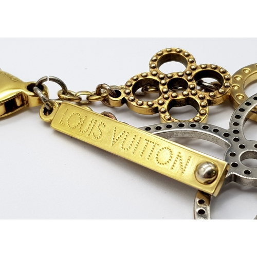 171 - A Louis Vuitton Bijoux Sac Tapage Charm/Key Ring. Gold and silver-toned hardware with iconic LV shap... 