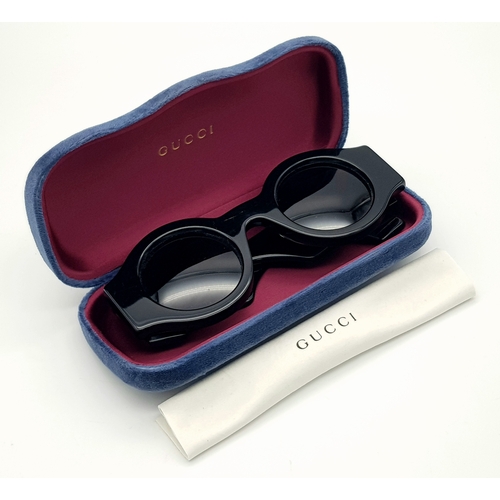 192 - A Pair of Gucci Black Round Sunglasses. Gold-toned GG logos to sides. Thick frames. Comes with case ... 