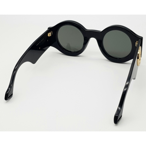 192 - A Pair of Gucci Black Round Sunglasses. Gold-toned GG logos to sides. Thick frames. Comes with case ... 