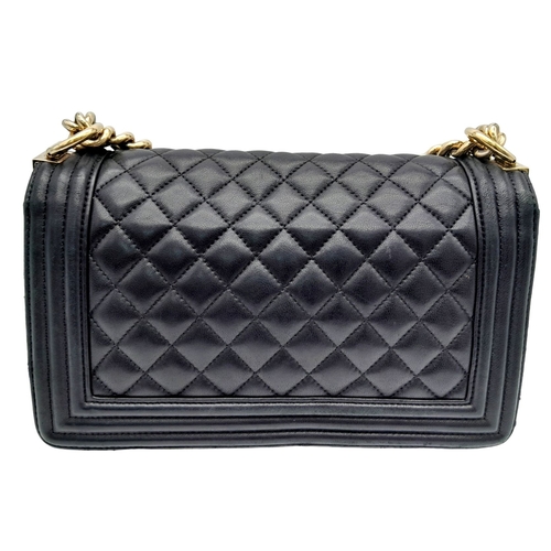 20 - A Chanel Black Boy Bag. Quilted leather exterior with gold-toned hardware, chain and leather adjusta... 