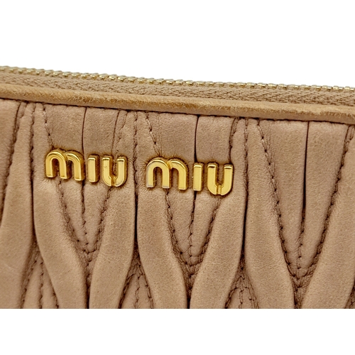 220 - A Miu Miu Dust Pink Purse. Matelassé leather exterior with gold-toned hardware and zipped top closur... 