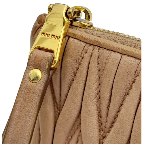 220 - A Miu Miu Dust Pink Purse. Matelassé leather exterior with gold-toned hardware and zipped top closur... 