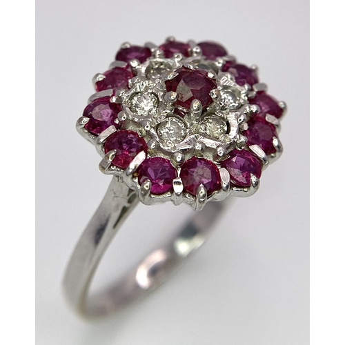 30 - A Gorgeous 18K White Gold, Ruby and Diamond Ring. Floral design on an elevated setting. 14 rubies an... 