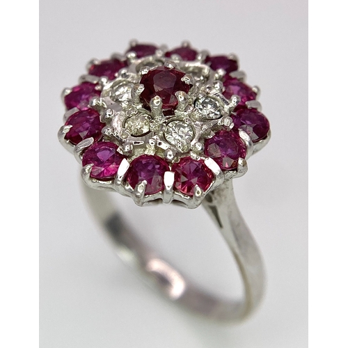 30 - A Gorgeous 18K White Gold, Ruby and Diamond Ring. Floral design on an elevated setting. 14 rubies an... 