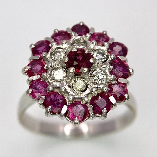 30 - A Gorgeous 18K White Gold, Ruby and Diamond Ring. Floral design on an elevated setting. 14 rubies an... 