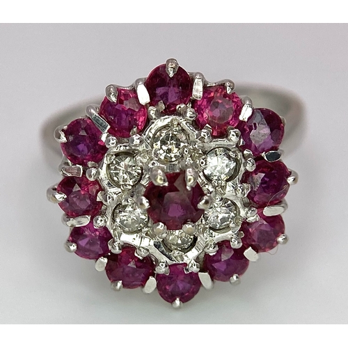 30 - A Gorgeous 18K White Gold, Ruby and Diamond Ring. Floral design on an elevated setting. 14 rubies an... 