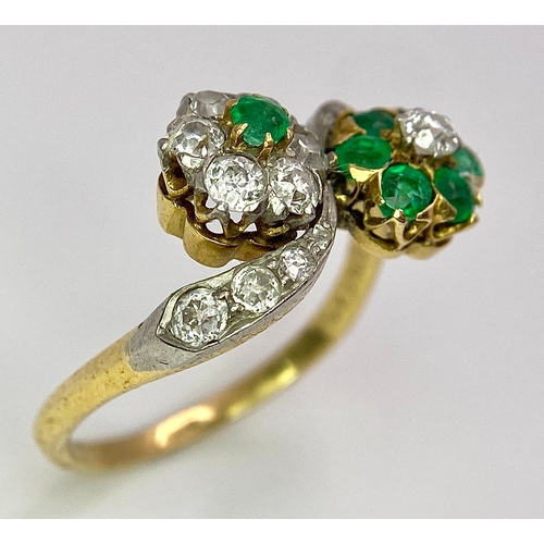 32 - A Vintage 18K Yellow Gold, Platinum, Emerald and Diamond Crossover Ring. Reverse flowers with emeral... 