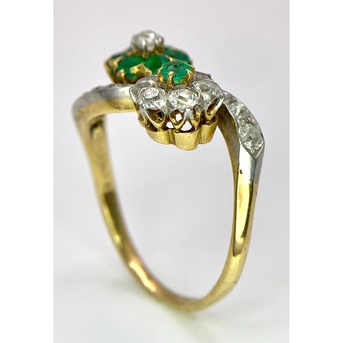 32 - A Vintage 18K Yellow Gold, Platinum, Emerald and Diamond Crossover Ring. Reverse flowers with emeral... 