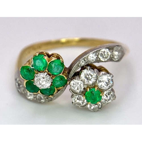 32 - A Vintage 18K Yellow Gold, Platinum, Emerald and Diamond Crossover Ring. Reverse flowers with emeral... 