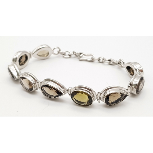 407 - A Silver Smoky Quartz Tennis Bracelet. Set in 925 Sterling silver. 39ctw.  W- 19.4g. Ref: HV2242