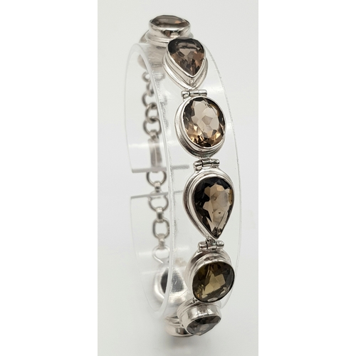 407 - A Silver Smoky Quartz Tennis Bracelet. Set in 925 Sterling silver. 39ctw.  W- 19.4g. Ref: HV2242