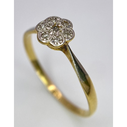 430 - An 18K Yellow Gold, Platinum Diamond Ring. Size Q. Seven old cut diamonds in a decorative floral pat... 