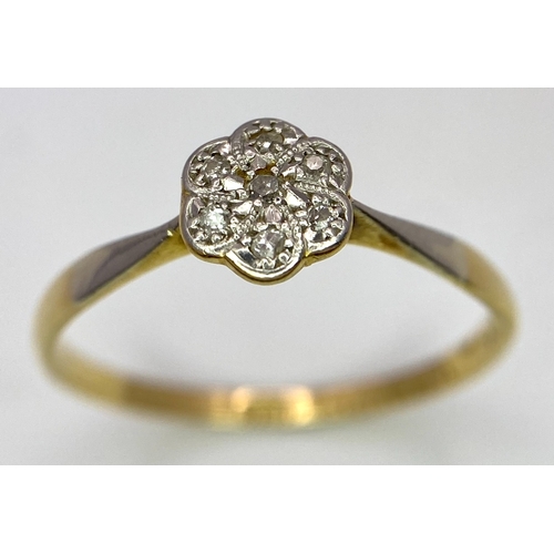 430 - An 18K Yellow Gold, Platinum Diamond Ring. Size Q. Seven old cut diamonds in a decorative floral pat... 