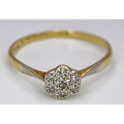 430 - An 18K Yellow Gold, Platinum Diamond Ring. Size Q. Seven old cut diamonds in a decorative floral pat... 