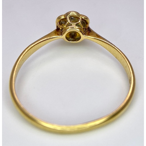 430 - An 18K Yellow Gold, Platinum Diamond Ring. Size Q. Seven old cut diamonds in a decorative floral pat... 