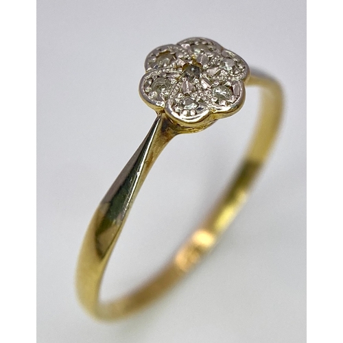 430 - An 18K Yellow Gold, Platinum Diamond Ring. Size Q. Seven old cut diamonds in a decorative floral pat... 