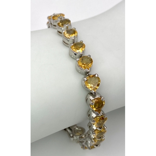 638 - A Citrine Heart-Cut Tennis Bracelet. Set in 925 Sterling silver. 34ctw. 19cm. HV2164