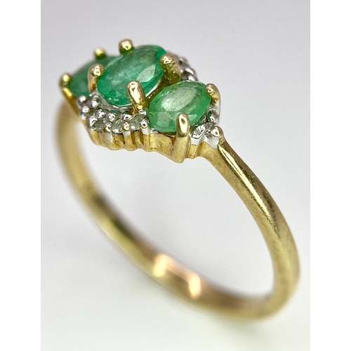 640 - A 9K Yellow Gold 3 Stone Emerald and Diamonds Ring. Size M, 1.8g total weight.