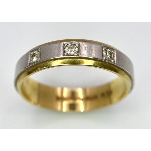 652 - An 18K Yellow and White Gild Three Diamond Band Ring. 0.10ctw diamonds. Size O. 5.2g weight.