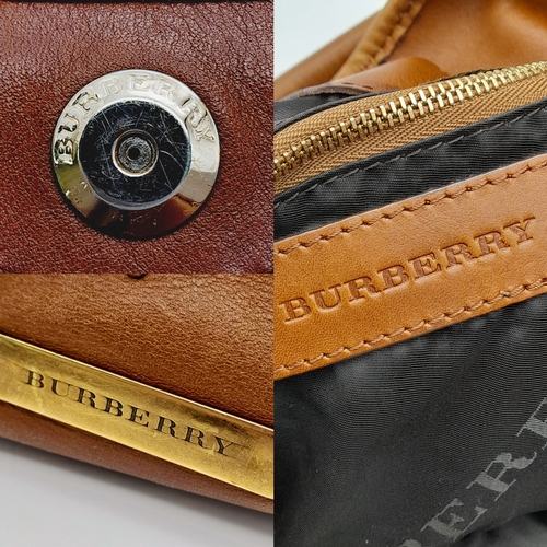 67 - A Burberry Tan Studded Heart Hobo Bag. Leather exterior with stud embellishments, golden-toned hardw... 