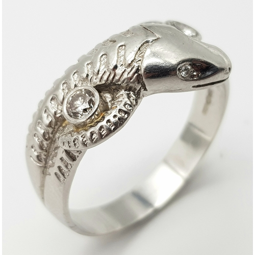 72 - A Very Large 950 Platinum and Diamond Snake Ring. A coiling serpent with diamond eyes and body. Size... 