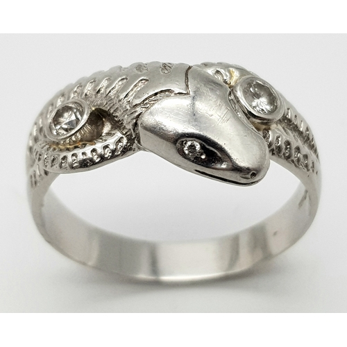 72 - A Very Large 950 Platinum and Diamond Snake Ring. A coiling serpent with diamond eyes and body. Size... 