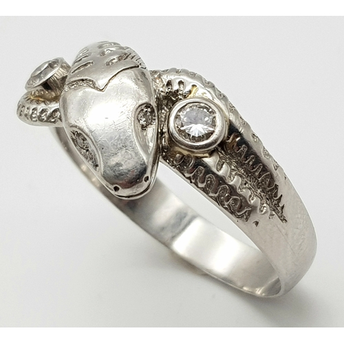 72 - A Very Large 950 Platinum and Diamond Snake Ring. A coiling serpent with diamond eyes and body. Size... 