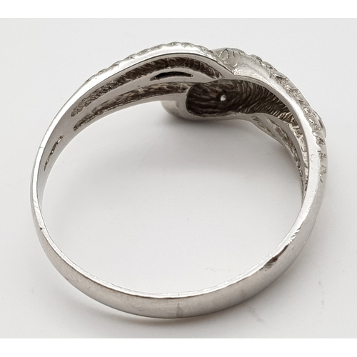 72 - A Very Large 950 Platinum and Diamond Snake Ring. A coiling serpent with diamond eyes and body. Size... 