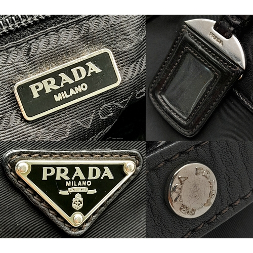 74 - A Prada Black Tessuto Satchel. Textile exterior with leather trim, silver-tone hardware, a top zip c... 