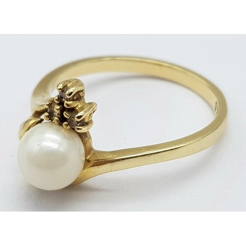 87 - A Vintage 14K Yellow Gold Pearl and Diamond Crossover Ring. Size M. 2.65g total weight.