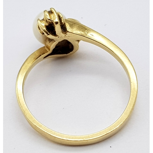 87 - A Vintage 14K Yellow Gold Pearl and Diamond Crossover Ring. Size M. 2.65g total weight.