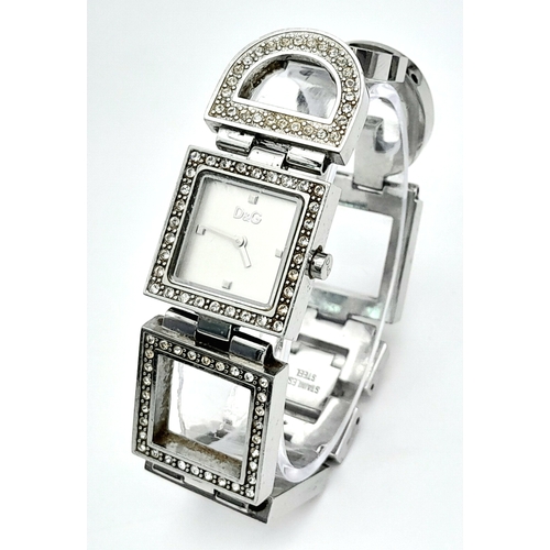 174 - The very iconic ladies DOLCE & GABBANA watch with the D & G logo studded in Swarovski crystals. Rect... 