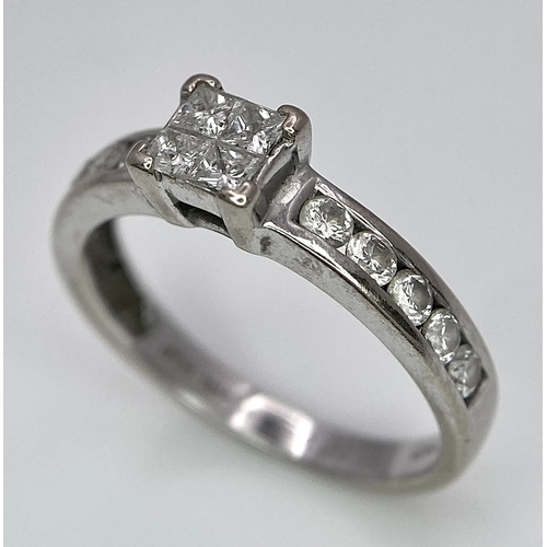 380 - An 18K White Gold and Diamond Ring. Square and round cut diamonds. Size J. 2.6g total weight.