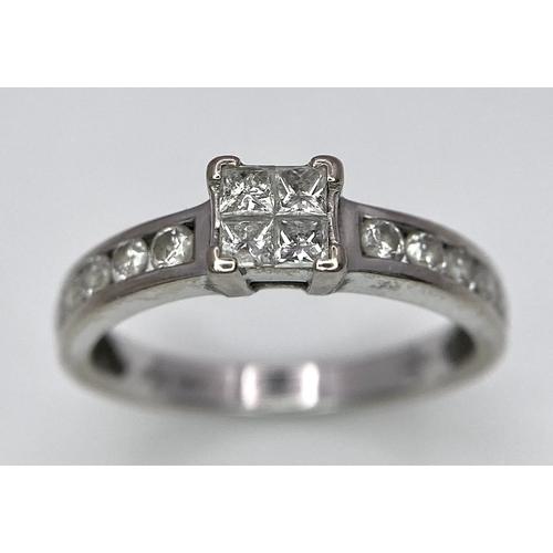 380 - An 18K White Gold and Diamond Ring. Square and round cut diamonds. Size J. 2.6g total weight.