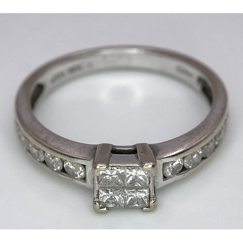 380 - An 18K White Gold and Diamond Ring. Square and round cut diamonds. Size J. 2.6g total weight.