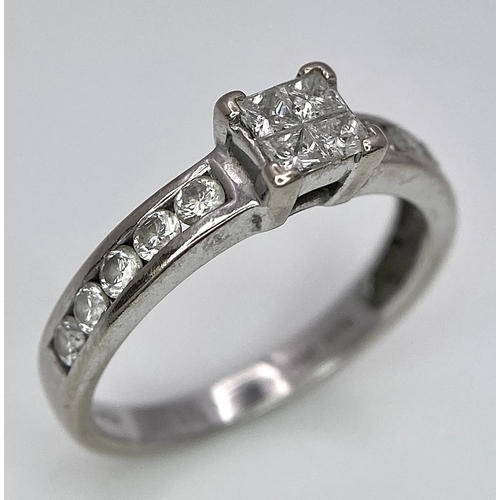 380 - An 18K White Gold and Diamond Ring. Square and round cut diamonds. Size J. 2.6g total weight.