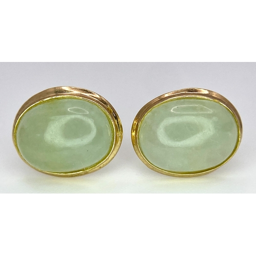 388 - A Pair of 9K Yellow Gold and Jade Stud Earrings. 1cm length, 1.5g total weight.