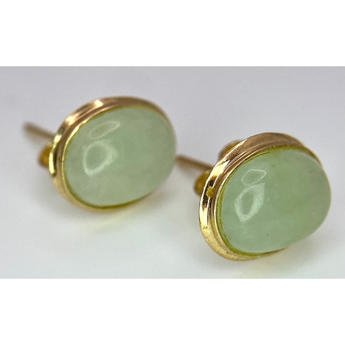 388 - A Pair of 9K Yellow Gold and Jade Stud Earrings. 1cm length, 1.5g total weight.