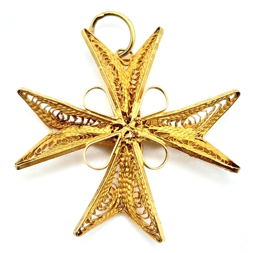 673 - An 18K Yellow Gold Decorative Filigree Cross Pendant. 3cm. 2.2g weight.