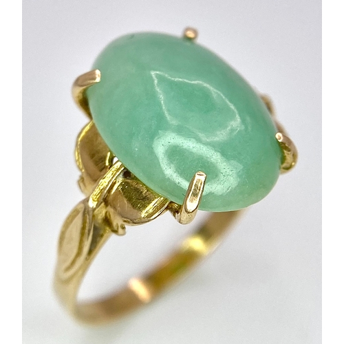 682 - A 9K Yellow Gold Jade Cabochon Ring. 1.8cm jade. Size L, 3.1g total weight.