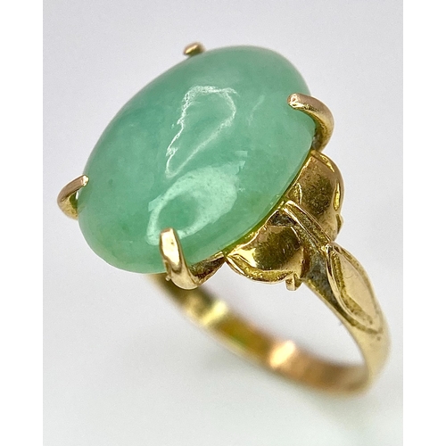 682 - A 9K Yellow Gold Jade Cabochon Ring. 1.8cm jade. Size L, 3.1g total weight.