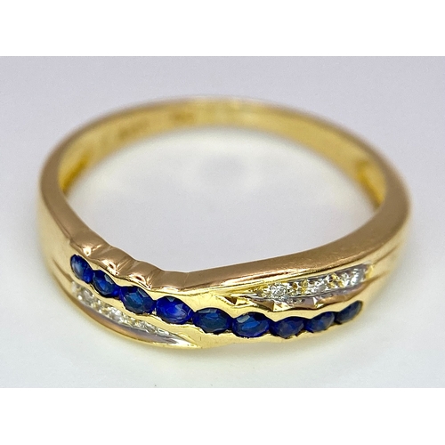 176 - AN 18K YELLOW GOLD DIAMOND & BLUE STONE (PROBABLY SAPPHIRE) CROSSOVER RING. Size O, 2.7g total weigh... 