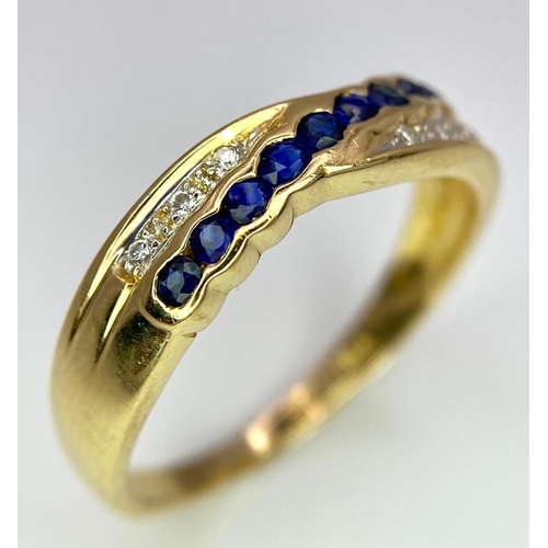 176 - AN 18K YELLOW GOLD DIAMOND & BLUE STONE (PROBABLY SAPPHIRE) CROSSOVER RING. Size O, 2.7g total weigh... 